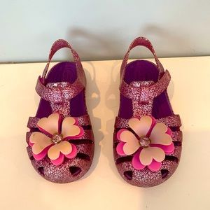 Crocs purple glitter sandals with flowers on toe box